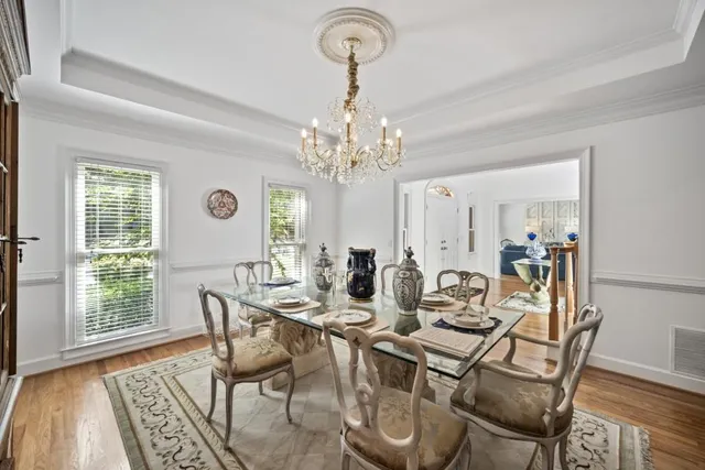 a view of a dining room with furniture and chandelier