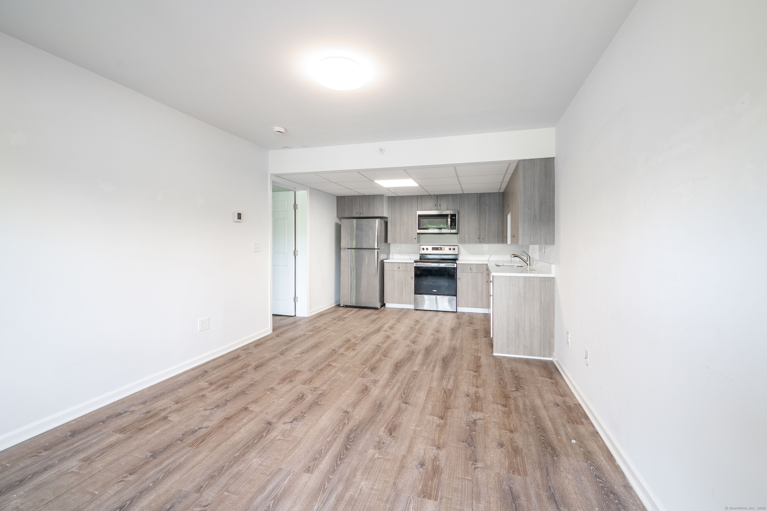 1030 Federal Road, Unit 201 Brookfield, CT 06804 - Photo 5 of 20 a view of kitchen and wooden floor