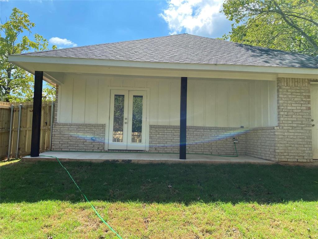 313 East Nelson Street Denison, TX 75021 - Photo 19 of 21 a view of a house with a yard