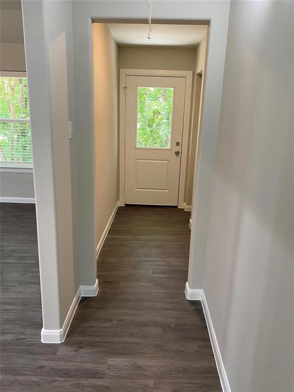 313 East Nelson Street Denison, TX 75021 - Photo 2 of 21 a view of a hallway with wooden floor and front door