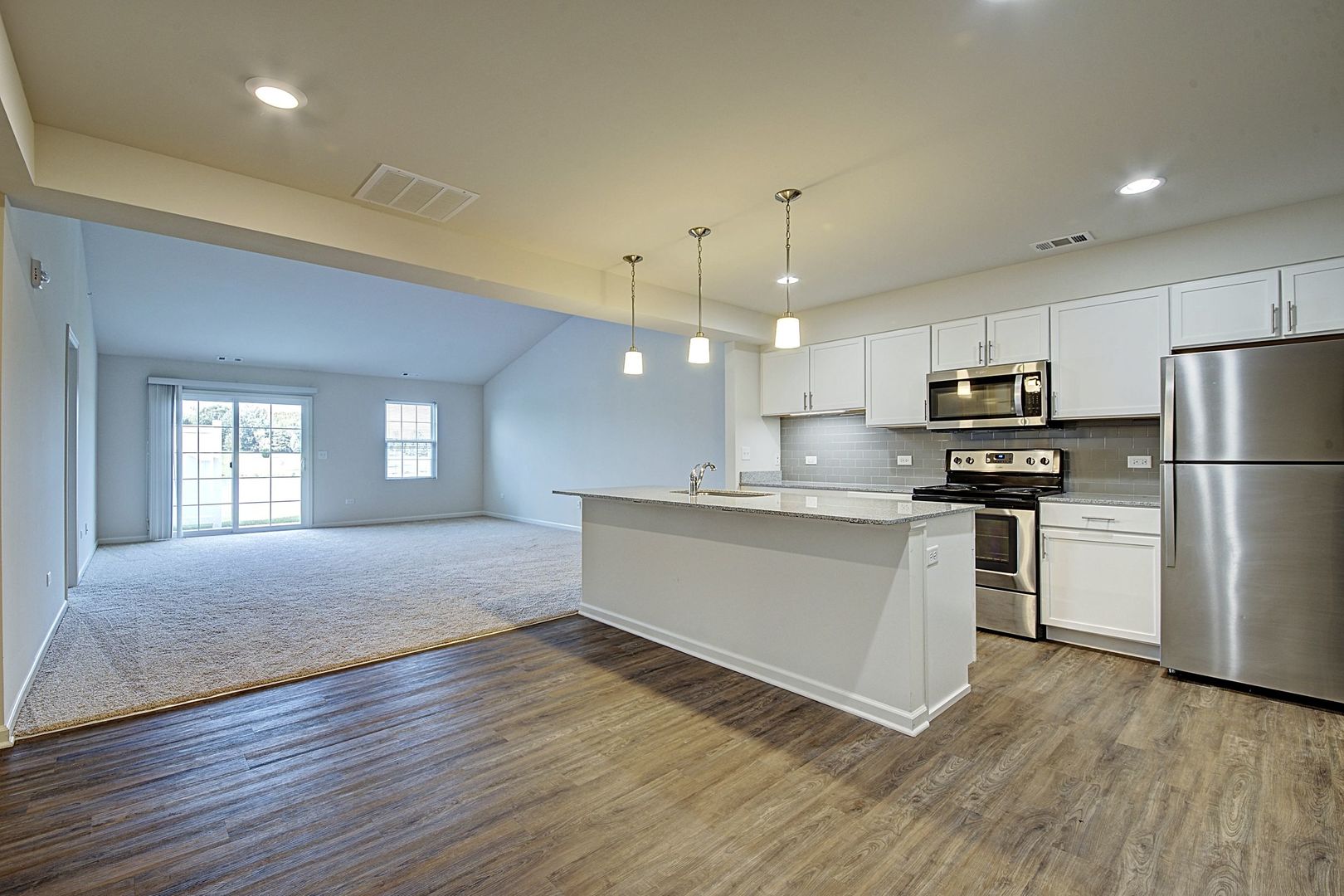 4205 Pond Willow Road Naperville, IL 60564 - Photo 12 of 18 a large kitchen with cabinets wooden floor and stainless steel appliances