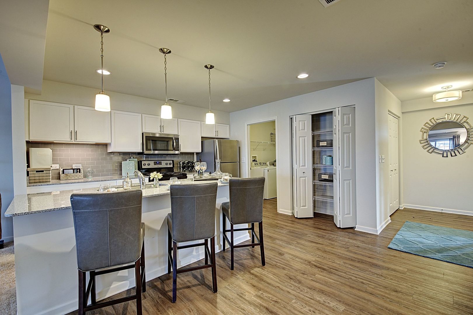 4205 Pond Willow Road Naperville, IL 60564 - Photo 3 of 18 a kitchen with stainless steel appliances granite countertop a dining table chairs refrigerator and microwave