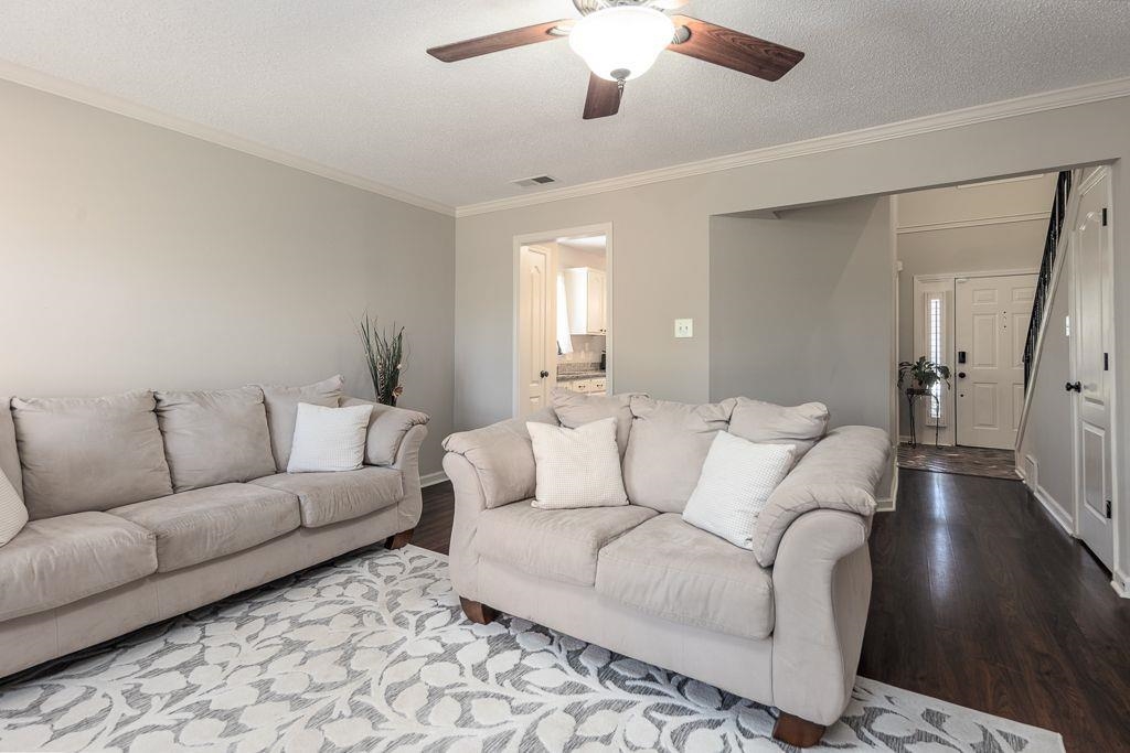 9768 Riggin Drive Memphis, TN 38002 - Photo 32 of 32 Living area with dark wood-finish flooring, light-toned walls, and a ceiling fan with integrated lighting
