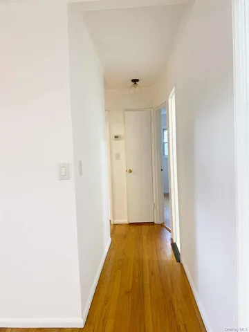 a view of a bathroom with wooden floor and a ceiling fan