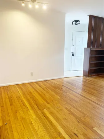 a view of a room with wooden floor and entryway