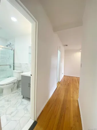 a view of an empty room and a window