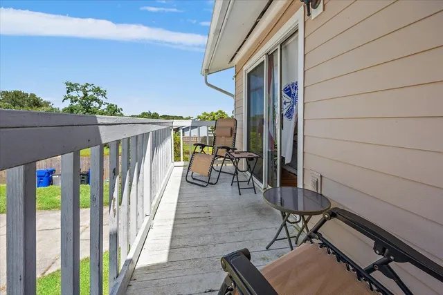 a view of balcony with wooden floor and outdoor seating