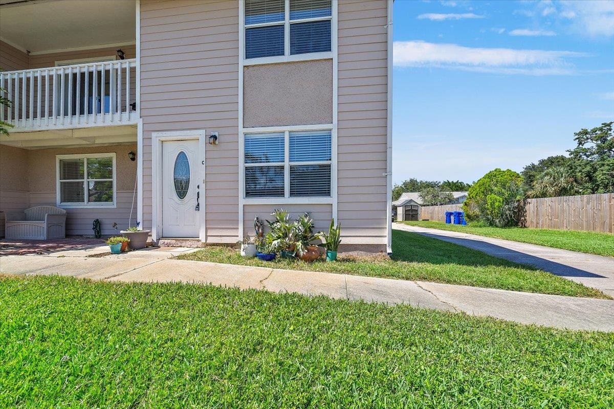 124 Rio Del Mar Street, Unit C St. Augustine, FL 32080 - Photo 16 of 27 a front view of a house with a yard