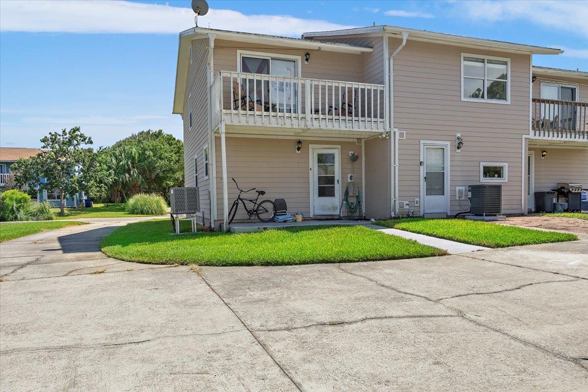 124 Rio Del Mar Street, Unit C St. Augustine, FL 32080 - Photo 19 of 27 a front view of a house with garden
