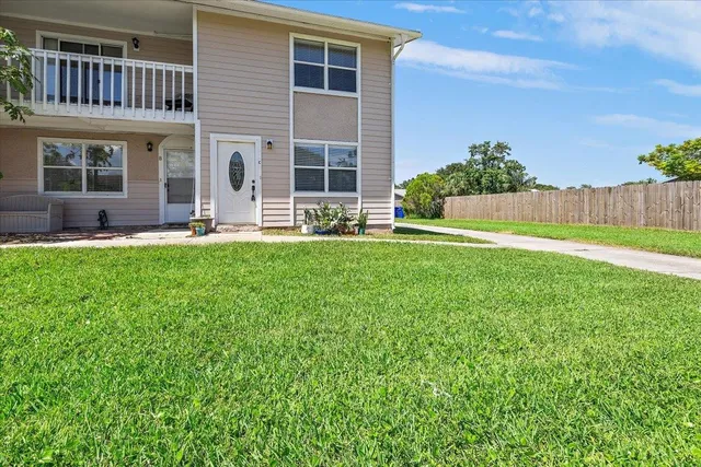 a house view with a sitting space and garden