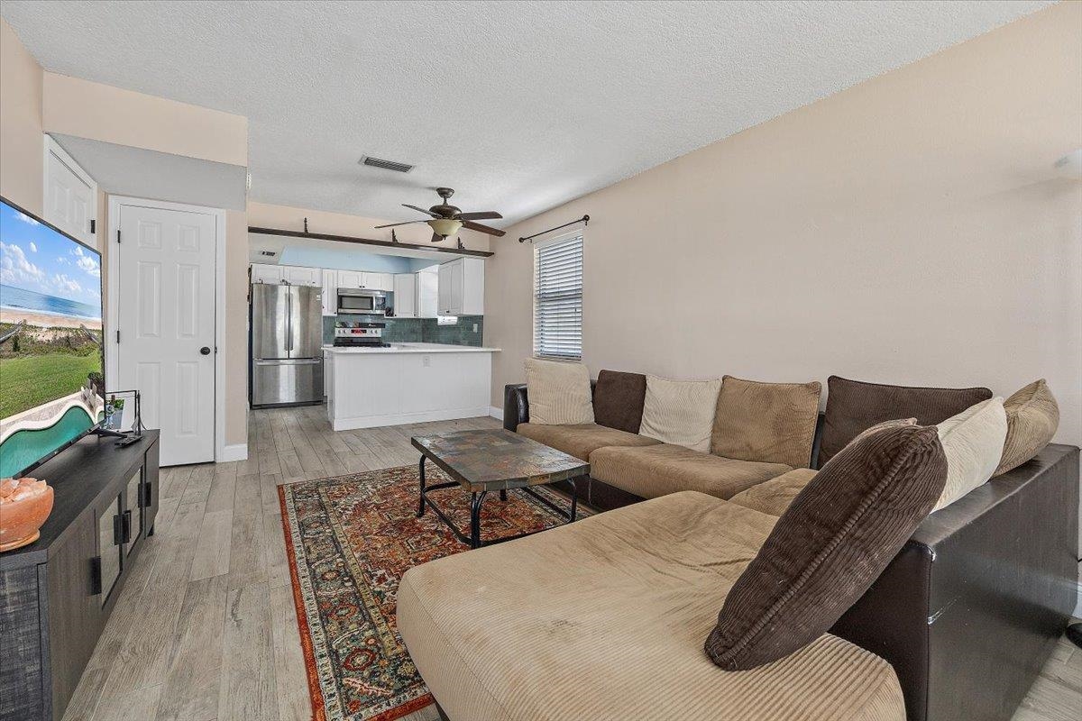 124 Rio Del Mar Street, Unit C St. Augustine, FL 32080 - Photo 4 of 27 a living room with furniture and a flat screen tv