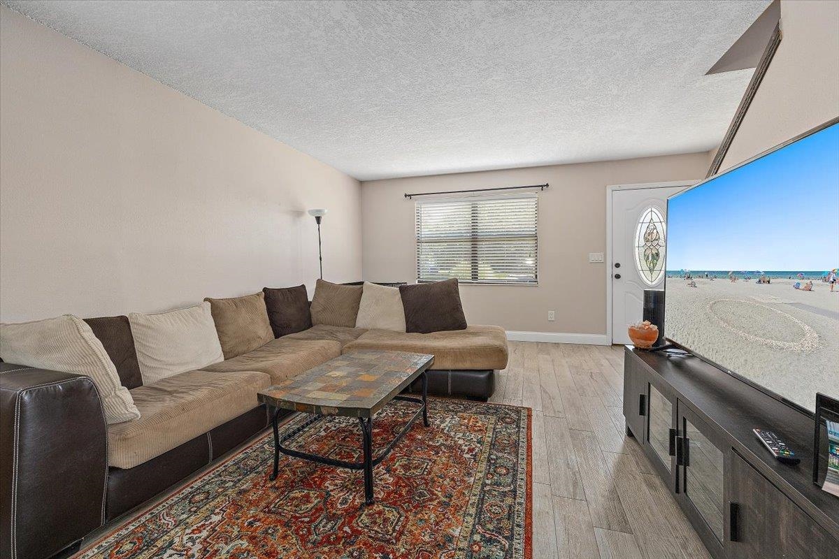 124 Rio Del Mar Street, Unit C St. Augustine, FL 32080 - Photo 5 of 27 a living room with furniture and a couch