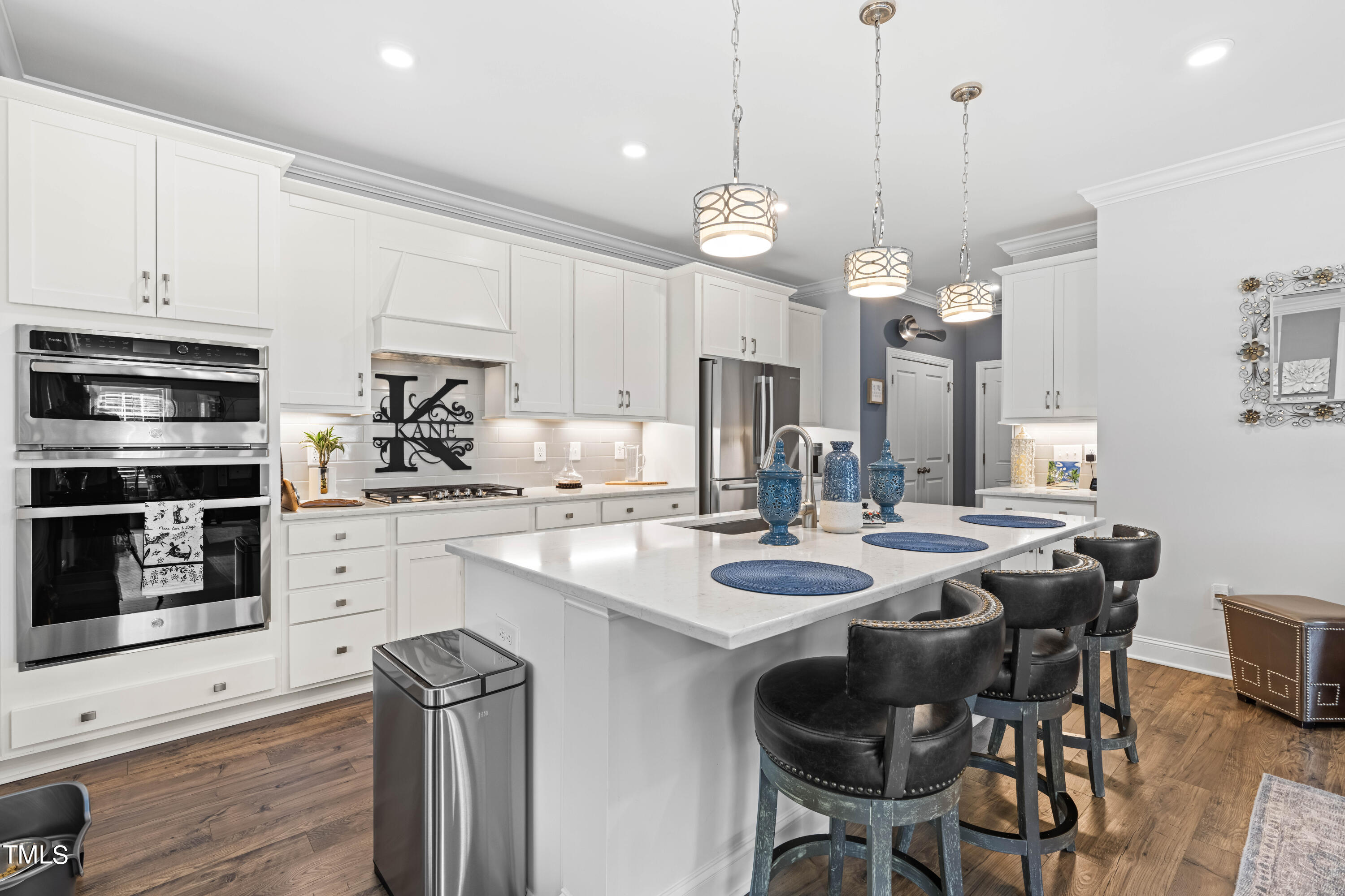 190 Hidden Bluff Drive Pittsboro, NC 27312 - Photo 20 of 58 a kitchen with stainless steel appliances kitchen island granite countertop a table chairs and a refrigerator