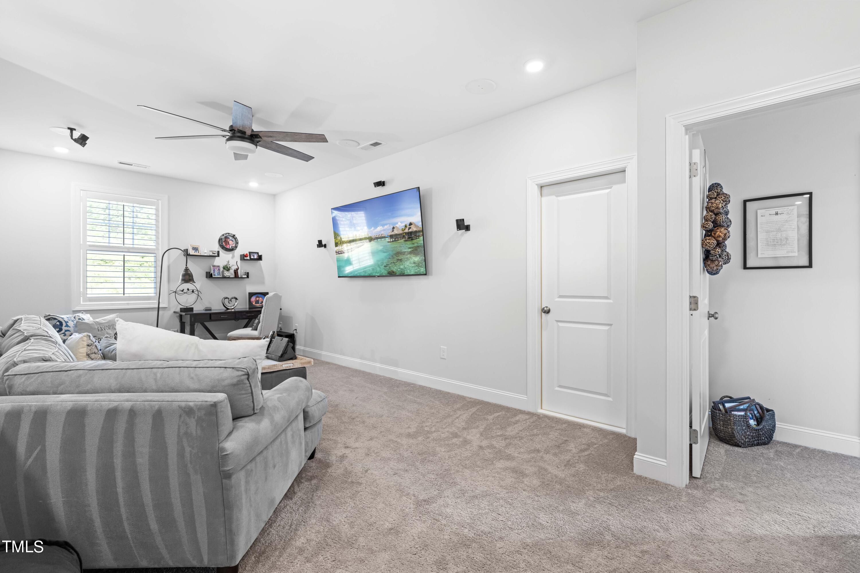 190 Hidden Bluff Drive Pittsboro, NC 27312 - Photo 34 of 58 a room with furniture and a flat screen tv