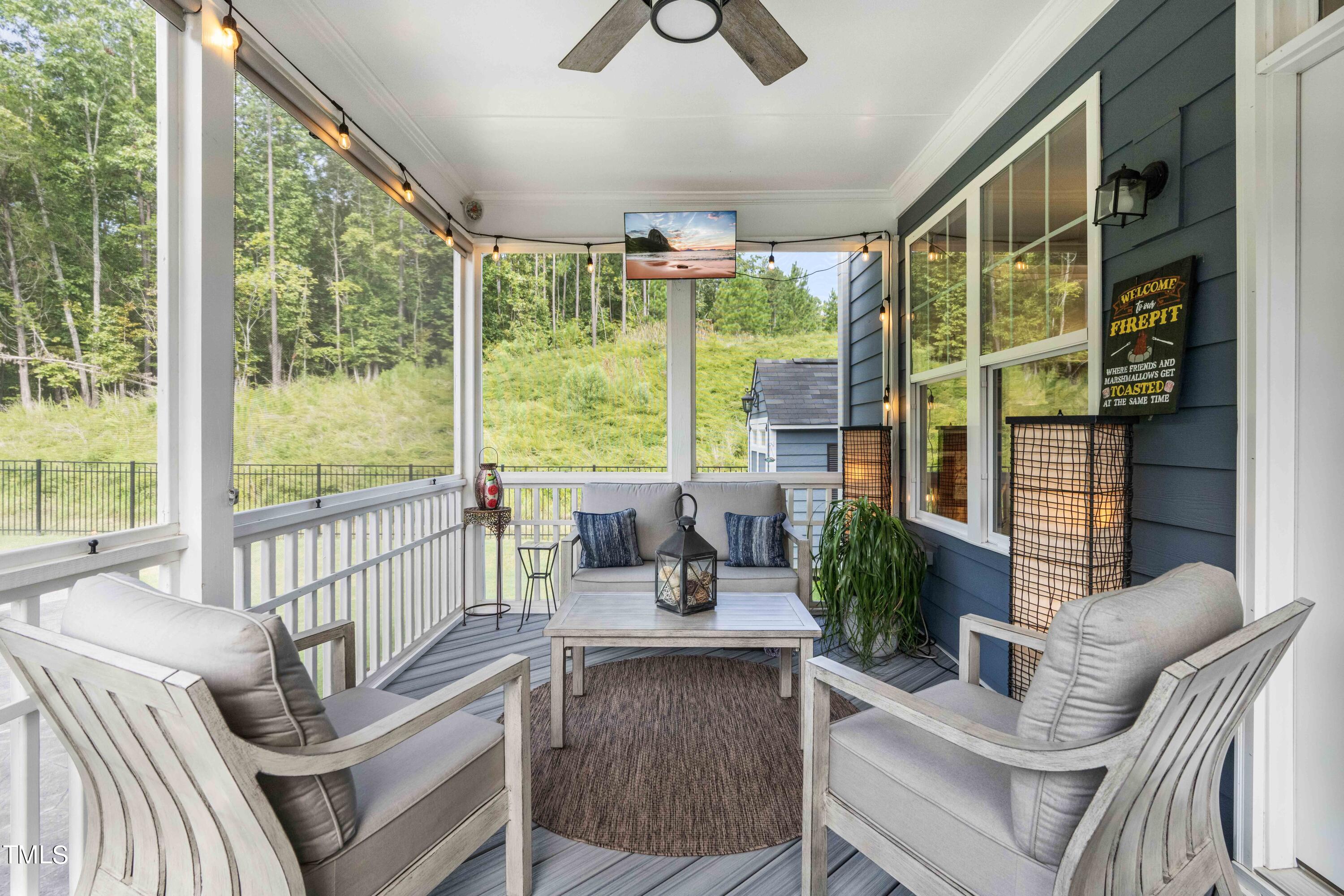 190 Hidden Bluff Drive Pittsboro, NC 27312 - Photo 47 of 58 a living room with furniture tv and a large window