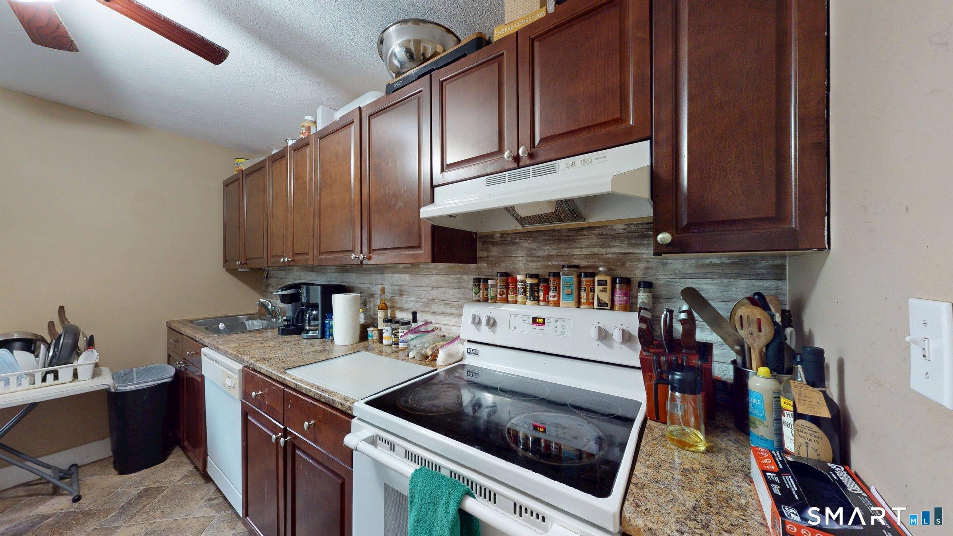138 Main Street Somers, CT 06071 - Photo 15 of 44 a kitchen with a cabinets and white appliances