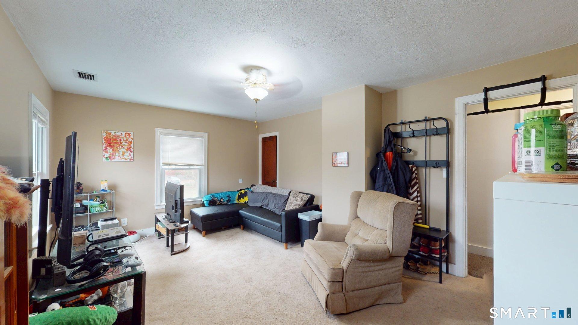 138 Main Street Somers, CT 06071 - Photo 18 of 44 a living room with furniture and a flat screen tv