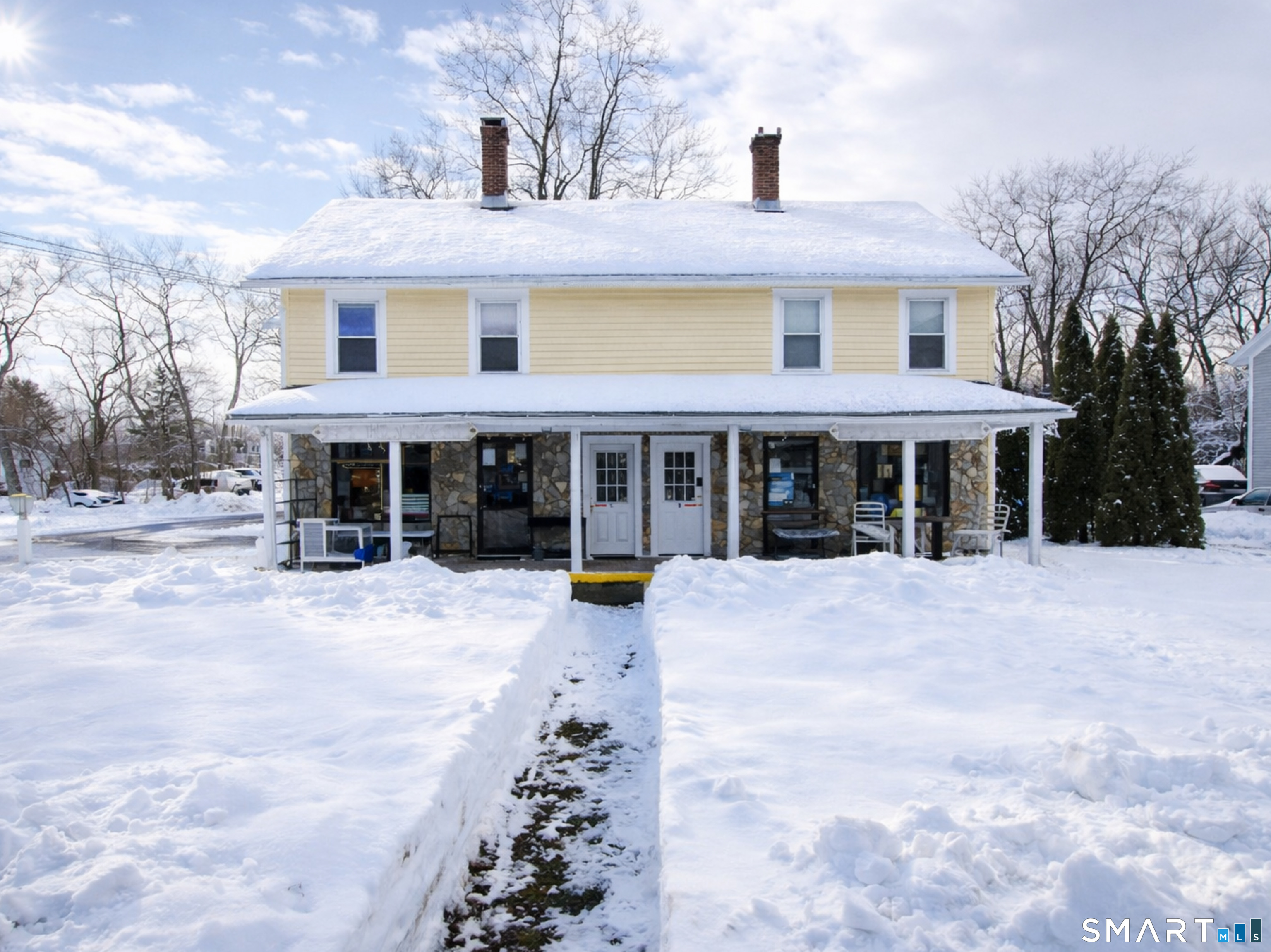 138 Main Street Somers, CT 06071 - Photo 2 of 44 a front view of a building with a yard and trees
