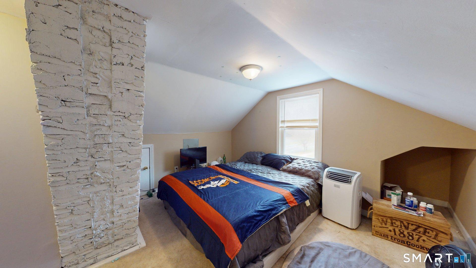 138 Main Street Somers, CT 06071 - Photo 22 of 44 a bed room with a bed tv and a window