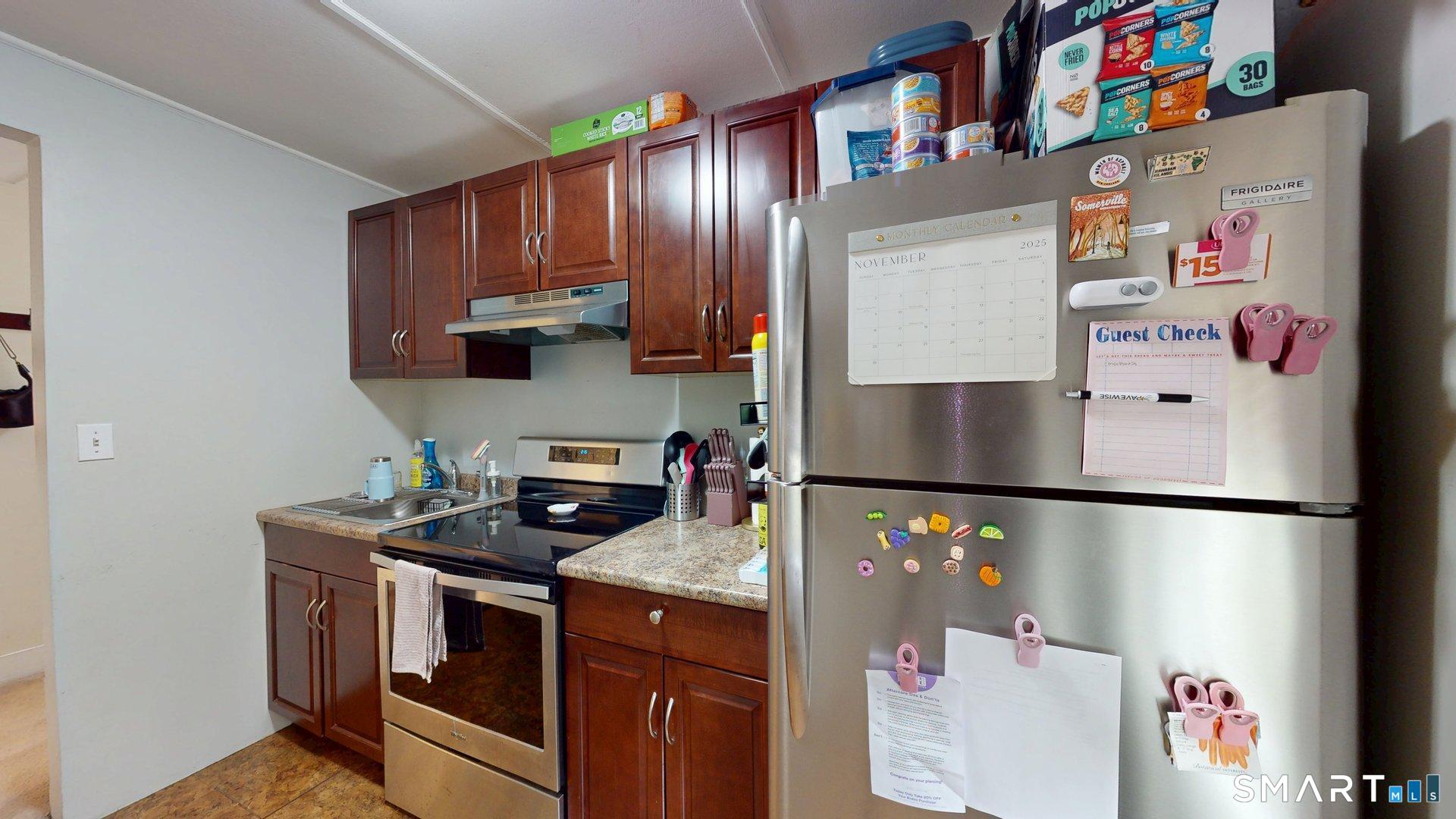 138 Main Street Somers, CT 06071 - Photo 27 of 44 a kitchen with a refrigerator and a microwave