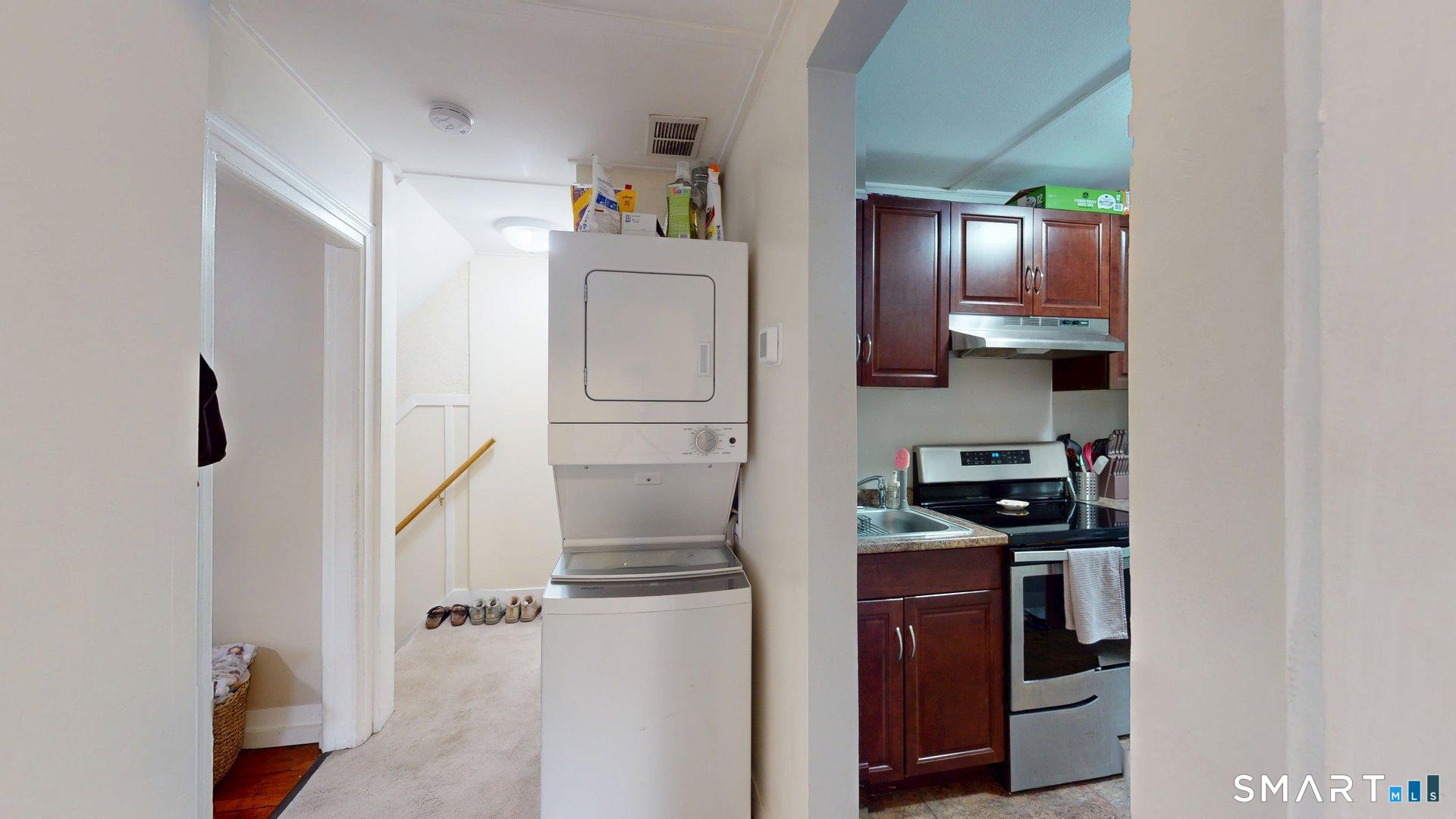 138 Main Street Somers, CT 06071 - Photo 28 of 44 a kitchen with a refrigerator and cabinets