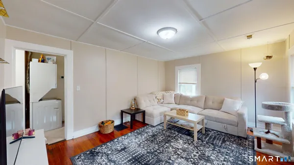 a bedroom with a bed and a refrigerator