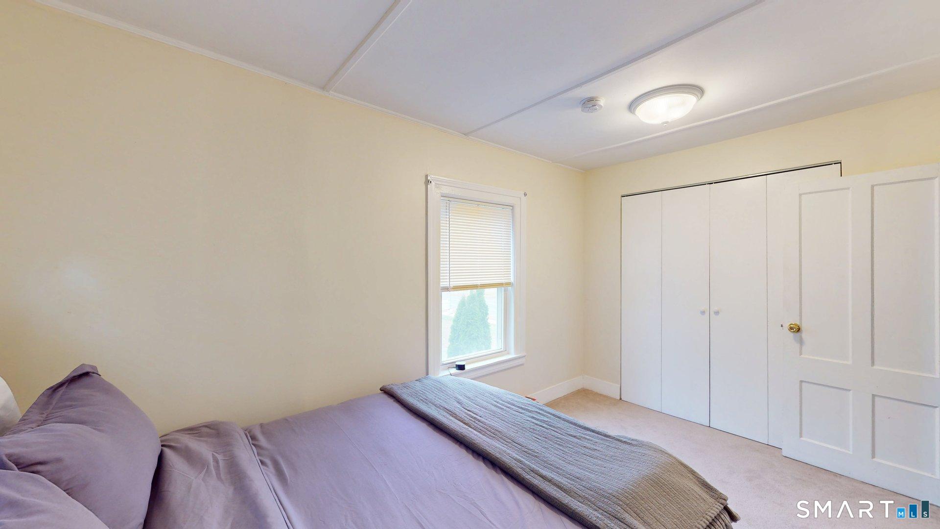 138 Main Street Somers, CT 06071 - Photo 34 of 44 a bedroom with a bed and a window