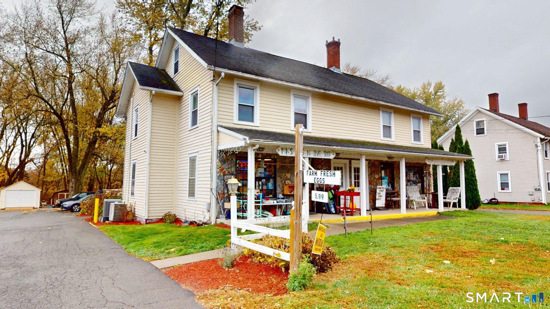 138 Main Street Somers, CT 06071 - Photo 38 of 44 a view of a white house with large windows and a yard