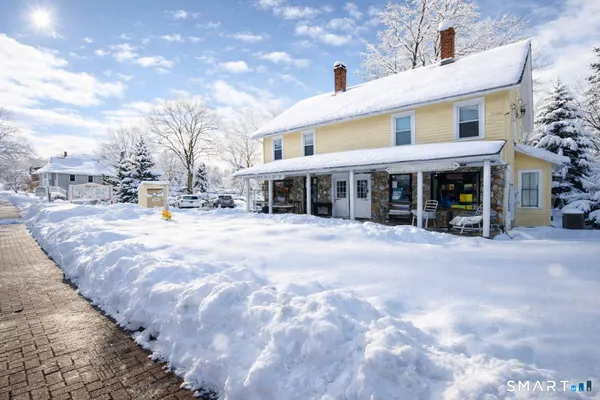 a view of a building with a snow on the road