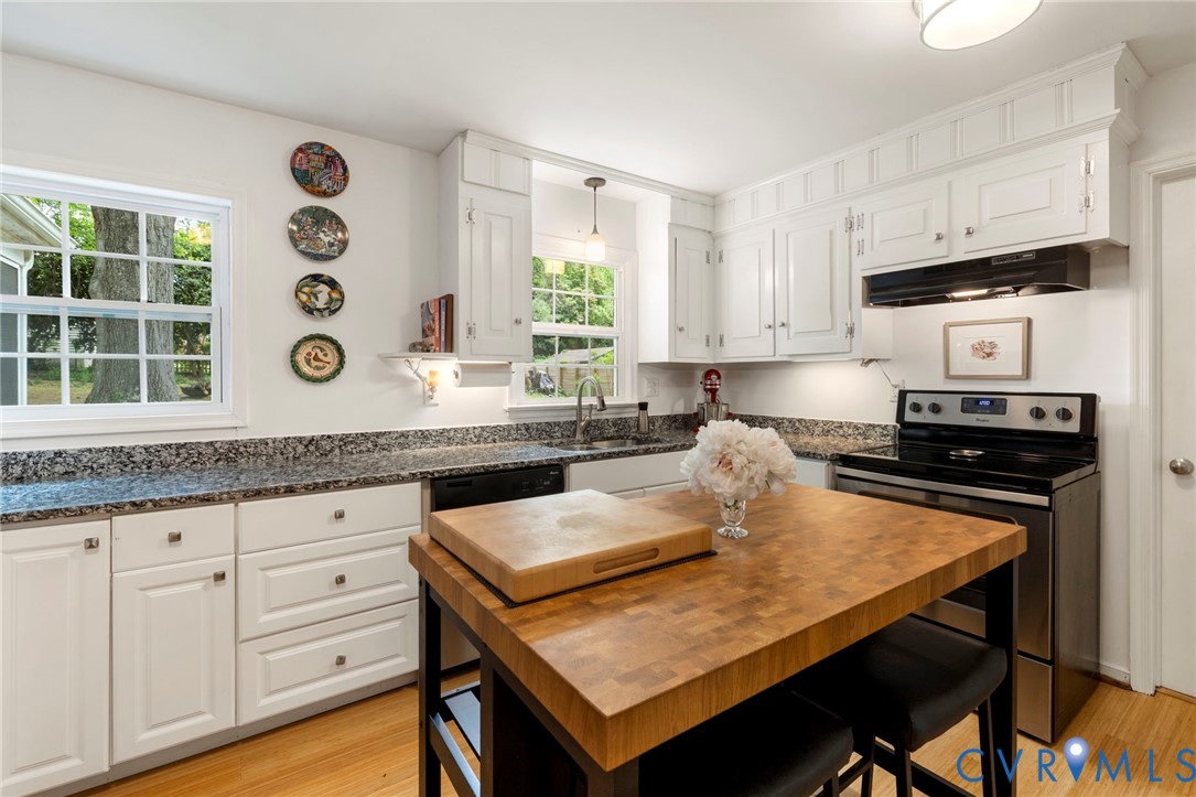 3311 Ottawa Road Richmond, VA 23225 - Photo 11 of 30 a kitchen with granite countertop a table chairs sink and cabinets