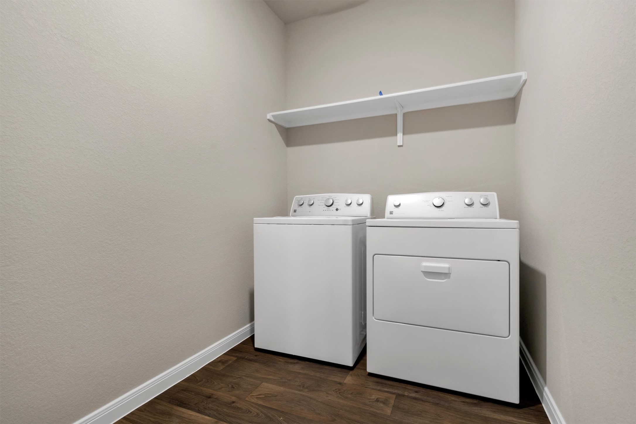 2909 Tweedy Trail Pflugerville, TX 78660 - Photo 20 of 27 Functional utility room featuring robust appliances and practical overhead storage.
