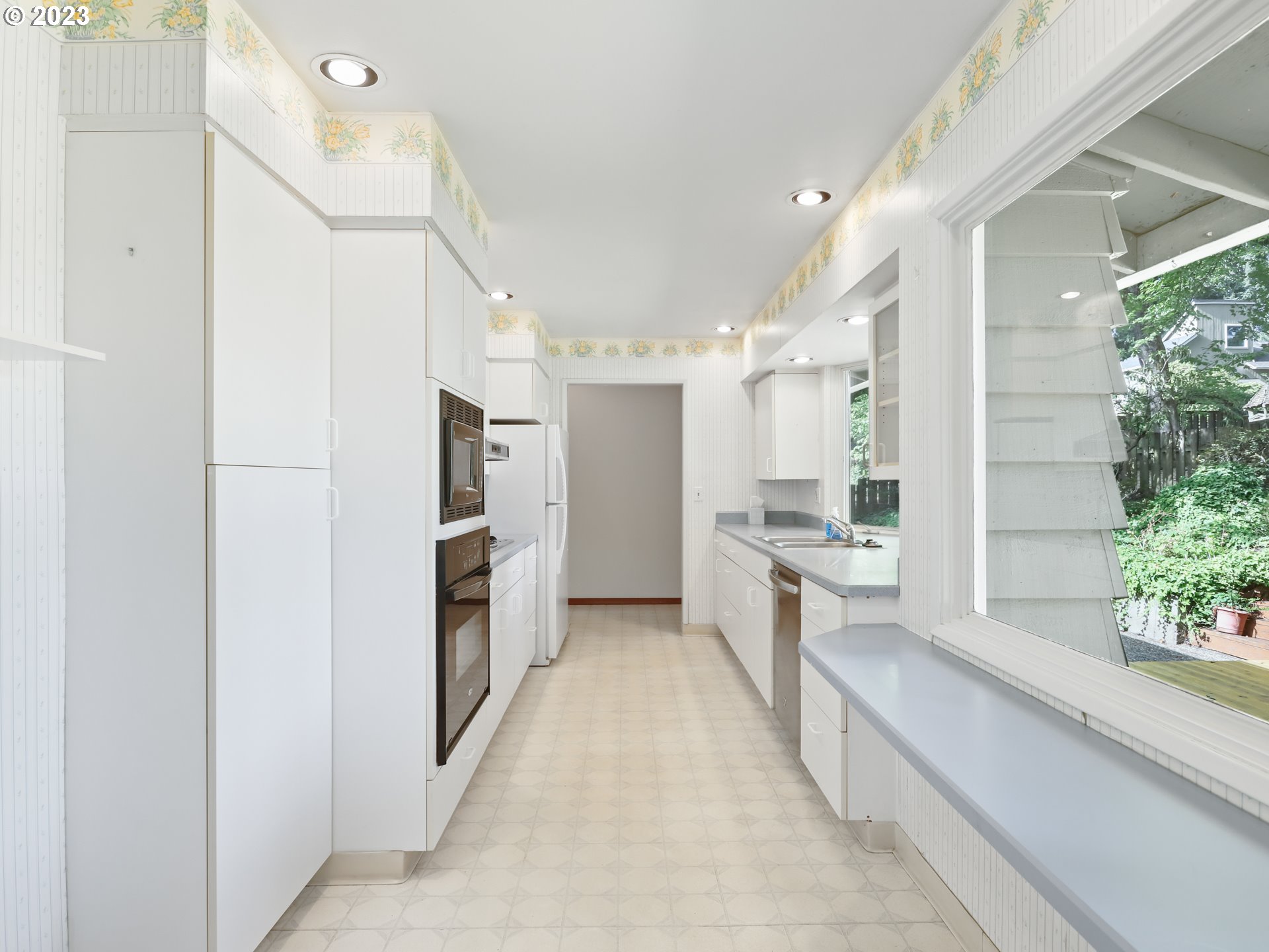 1975 Mapleleaf Road Lake Oswego, OR 97034 - Photo 13 of 37 a large white kitchen with a refrigerator a stove and a window