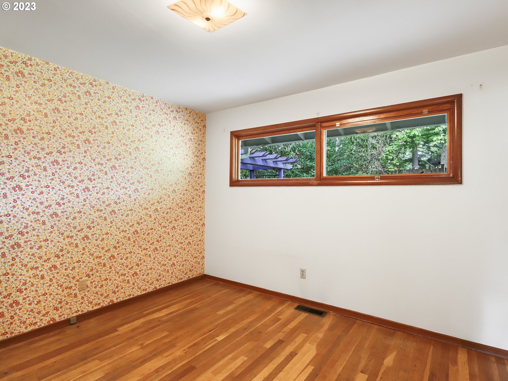 1975 Mapleleaf Road Lake Oswego, OR 97034 - Photo 20 of 37 a view of an empty room with wooden floor and a window