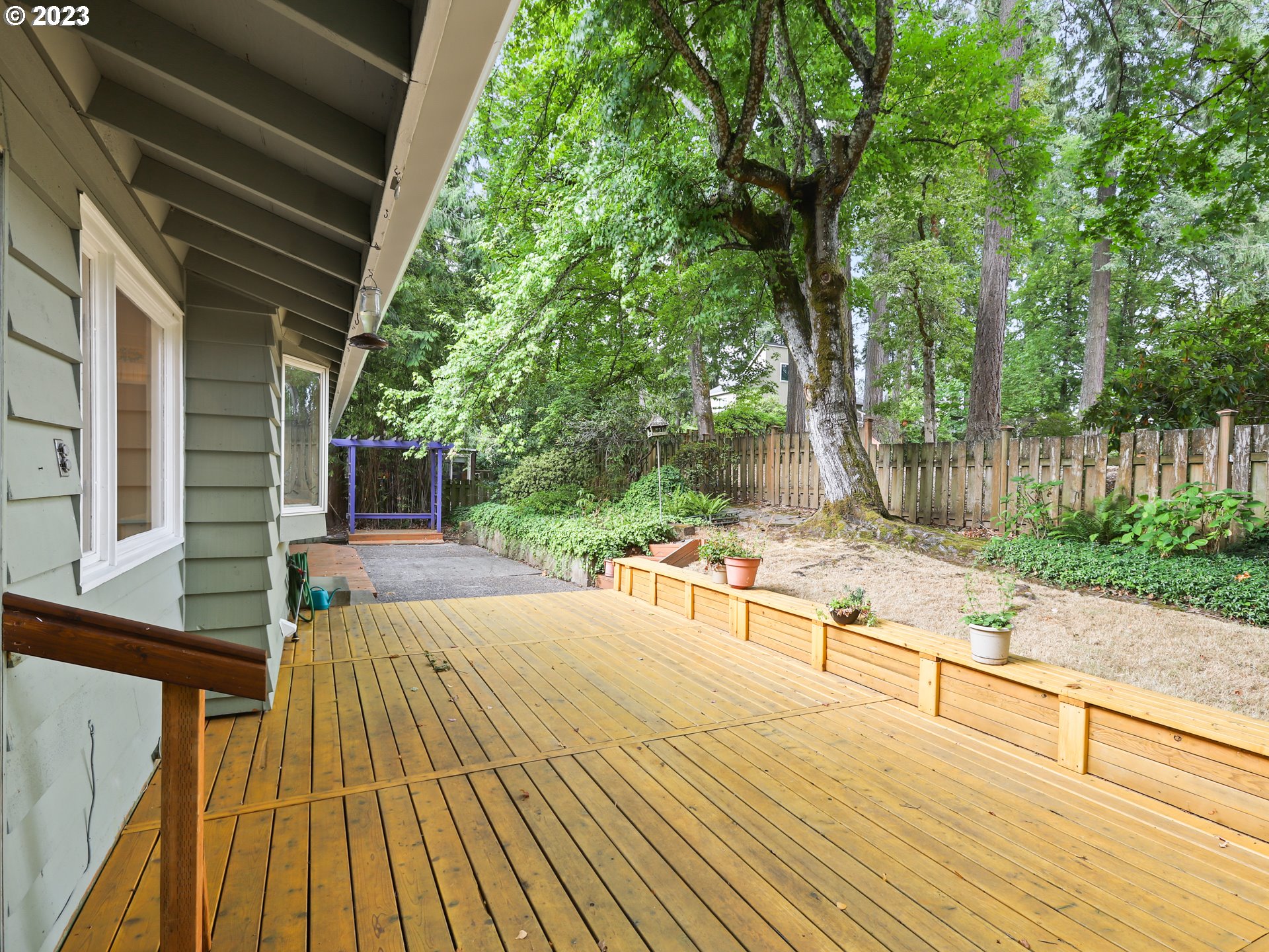 1975 Mapleleaf Road Lake Oswego, OR 97034 - Photo 32 of 37 a view of backyard with a large tree and wooden fence