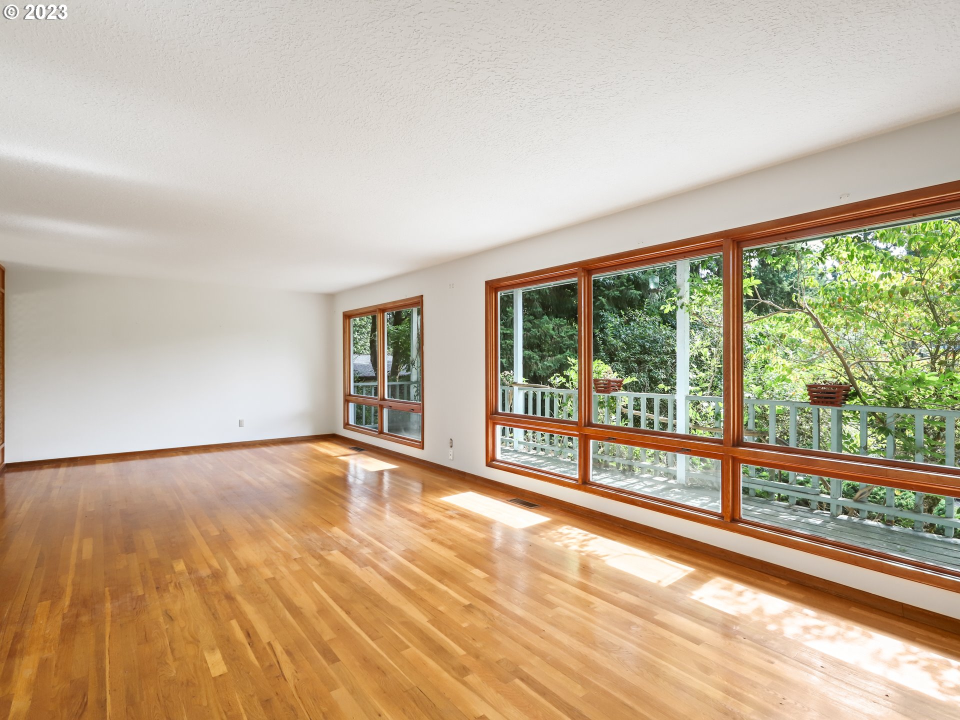 1975 Mapleleaf Road Lake Oswego, OR 97034 - Photo 8 of 37 a view of an empty room with wooden floor and a window