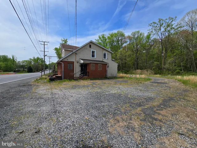 a view of a house with a yard and sitting area