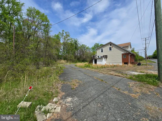 a view of a house with a yard and tree s