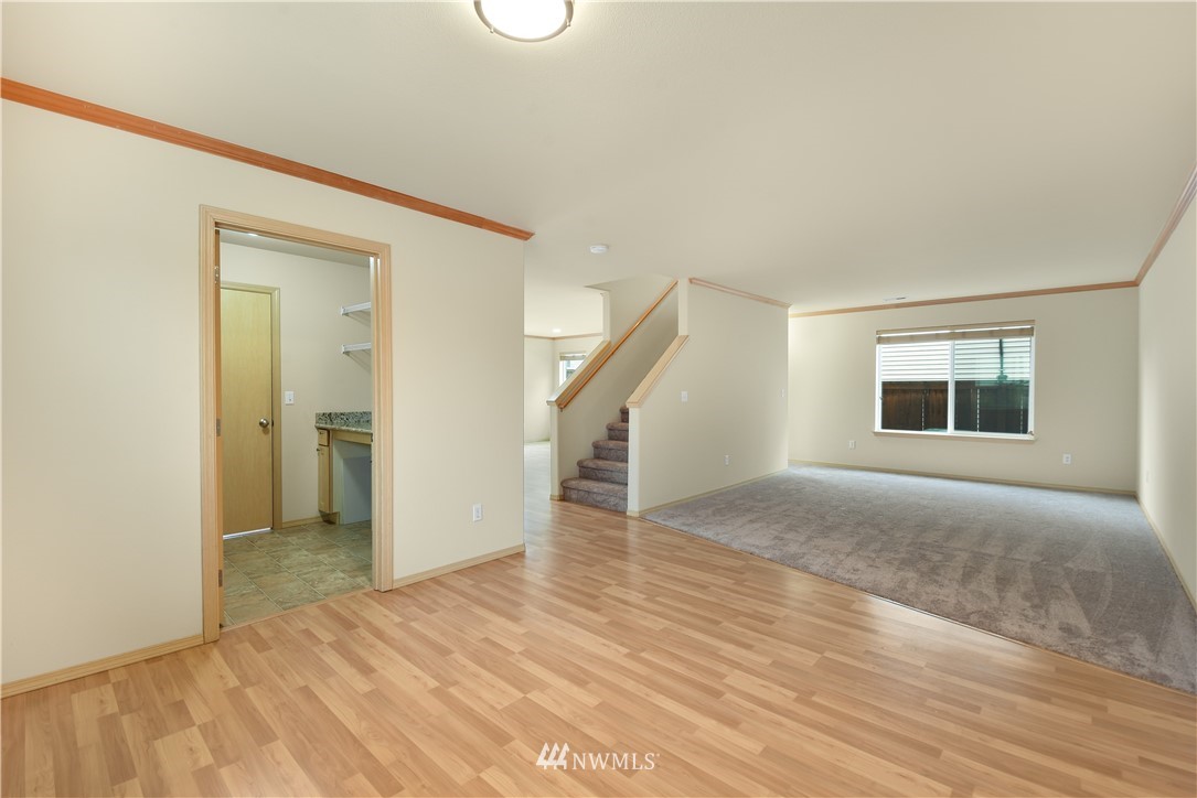 20317 Corbridge Road Southeast Monroe, WA 98272 - Photo 7 of 33 a view of an empty room with wooden floor and a window