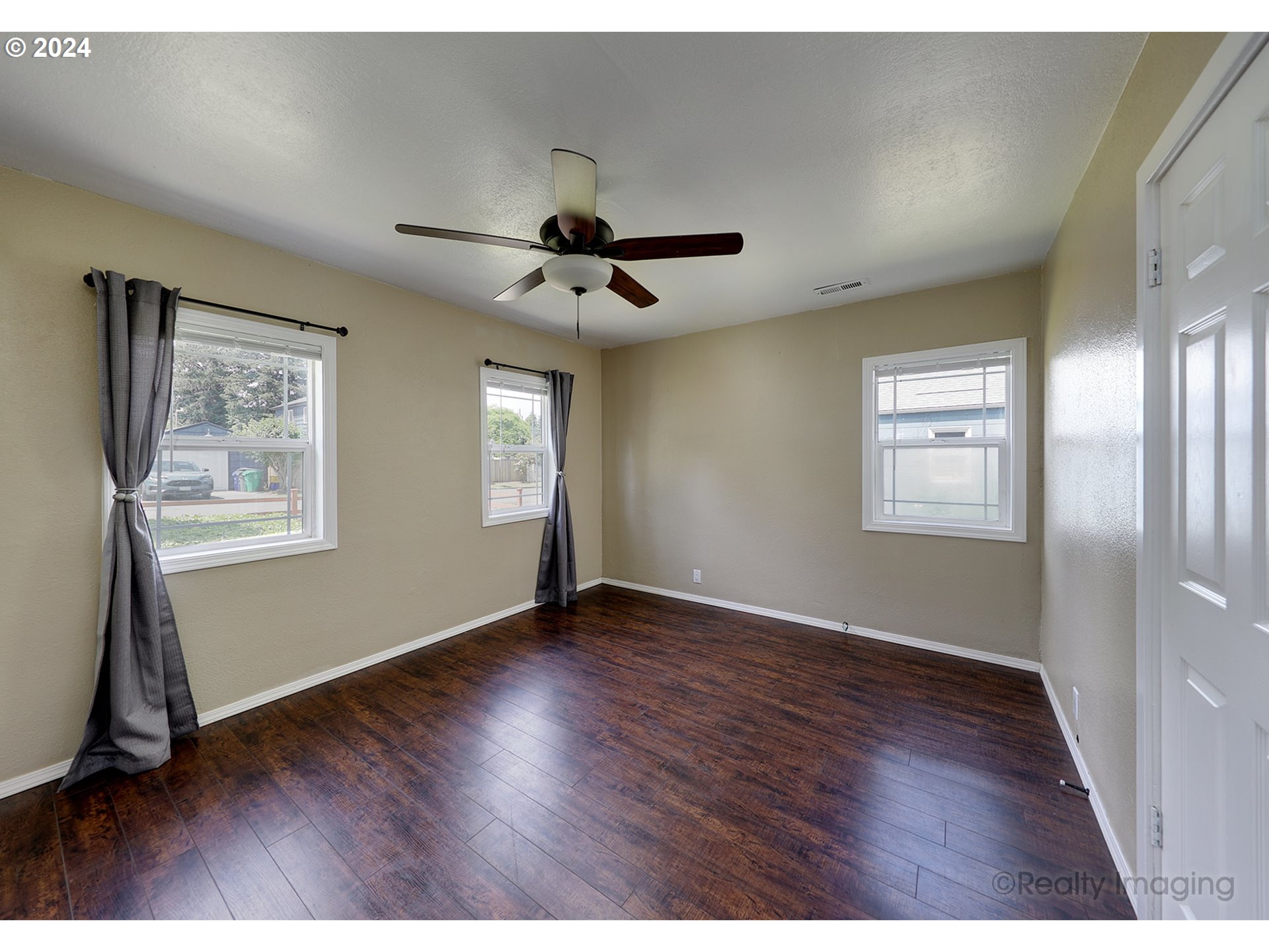 4424 Northeast 115th Avenue Portland, OR 97220 - Photo 12 of 24 a view of an empty room with a window and wooden floor