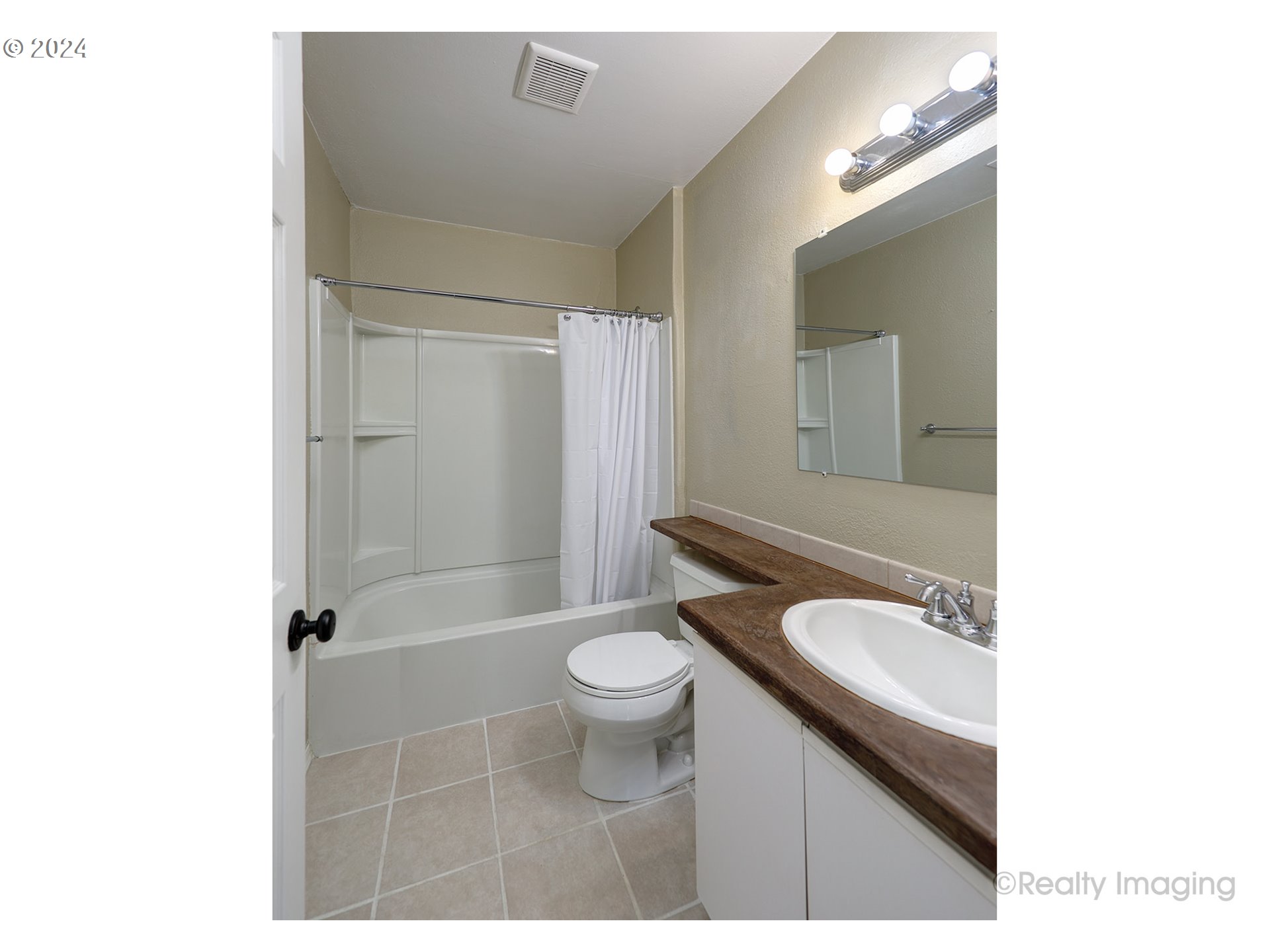 4424 Northeast 115th Avenue Portland, OR 97220 - Photo 14 of 24 a bathroom with a granite countertop toilet a sink and a mirror