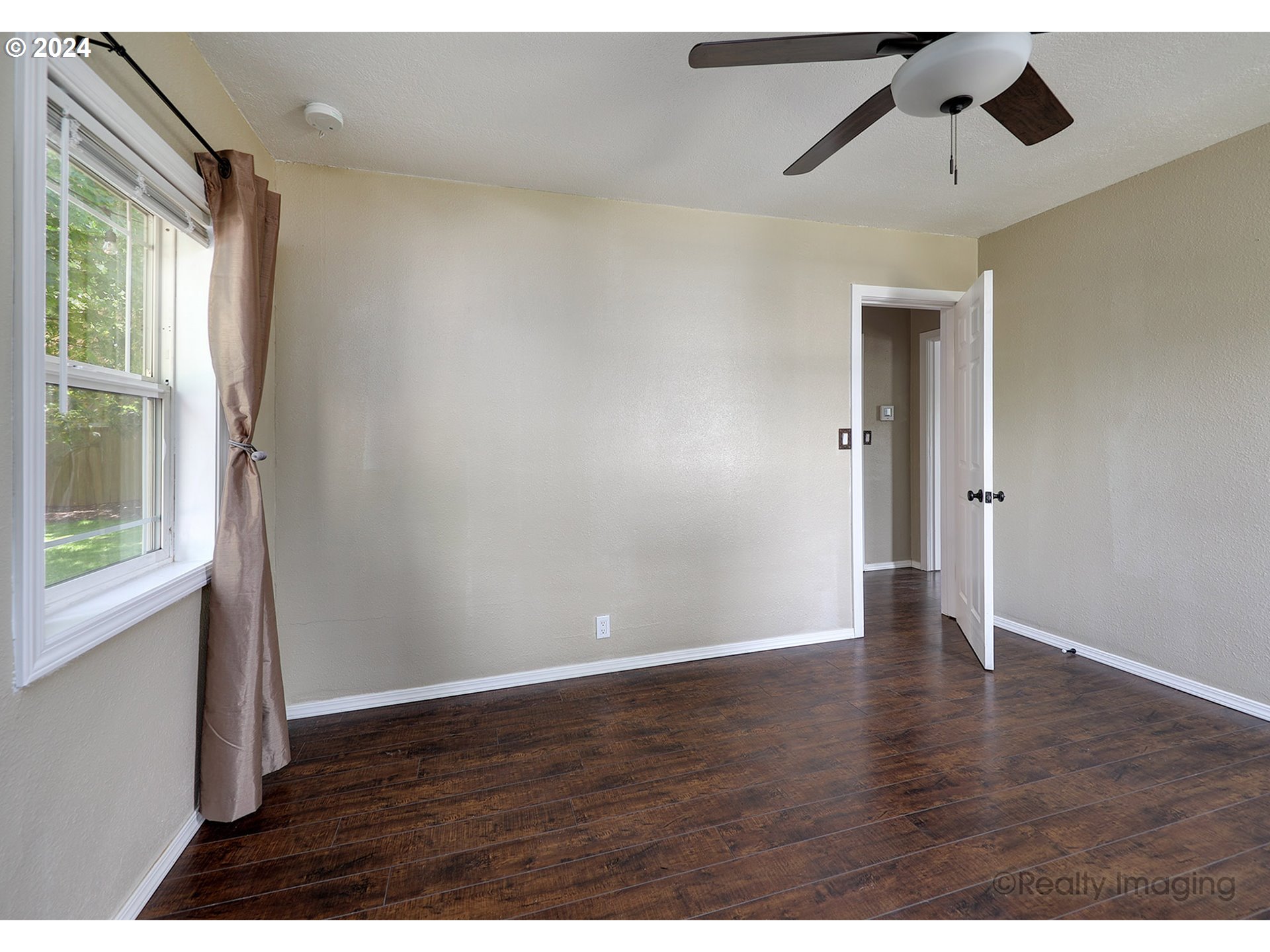 4424 Northeast 115th Avenue Portland, OR 97220 - Photo 16 of 24 a view of an empty room with wooden floor and a window