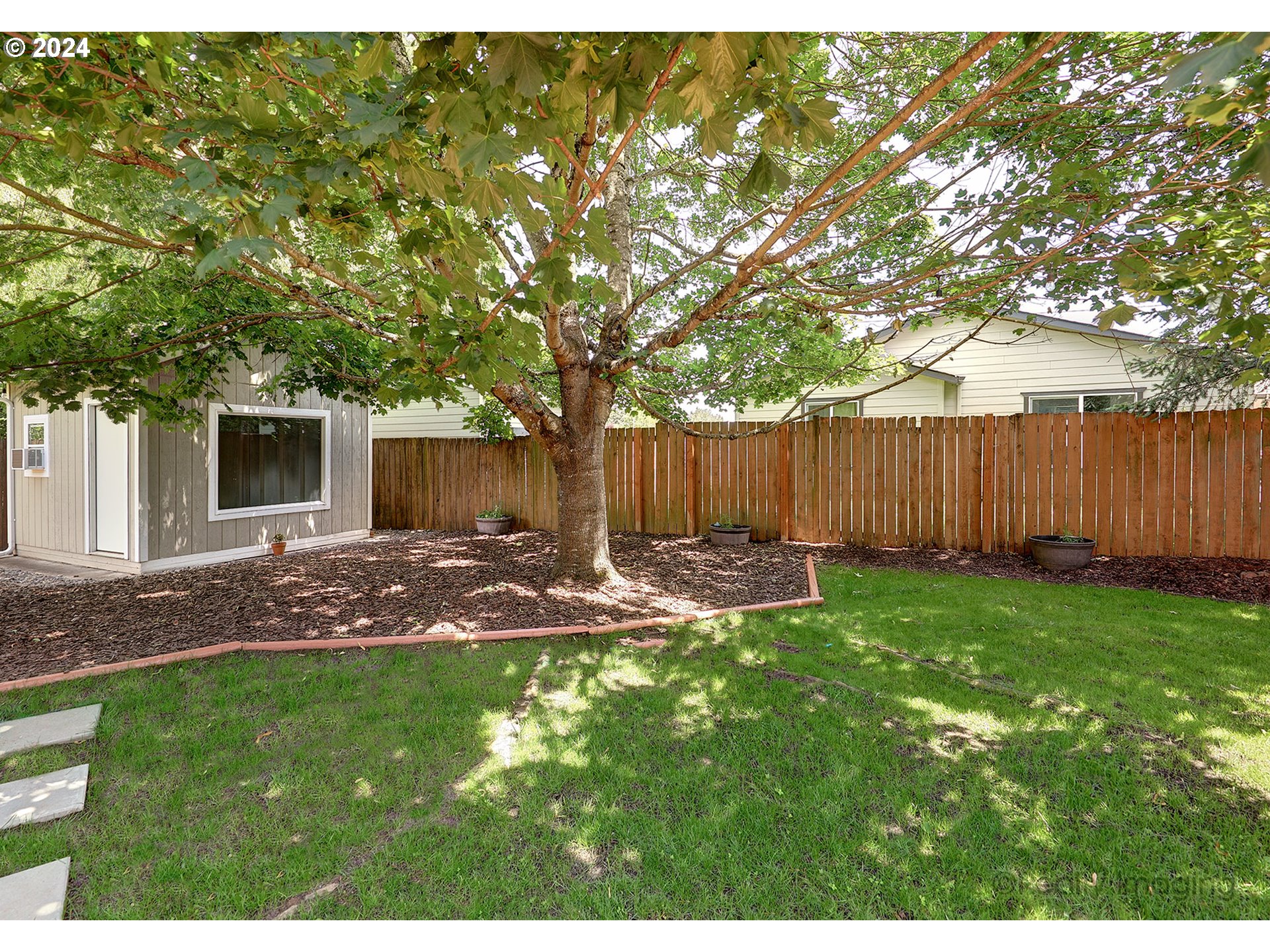 4424 Northeast 115th Avenue Portland, OR 97220 - Photo 18 of 24 a view of a backyard with table and chairs and wooden fence