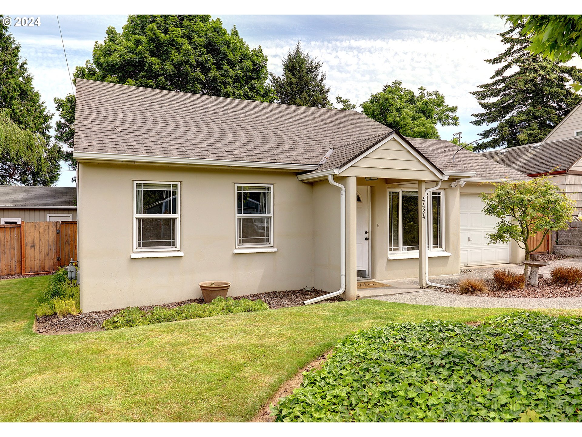 4424 Northeast 115th Avenue Portland, OR 97220 - Photo 4 of 24 a house view with a garden space