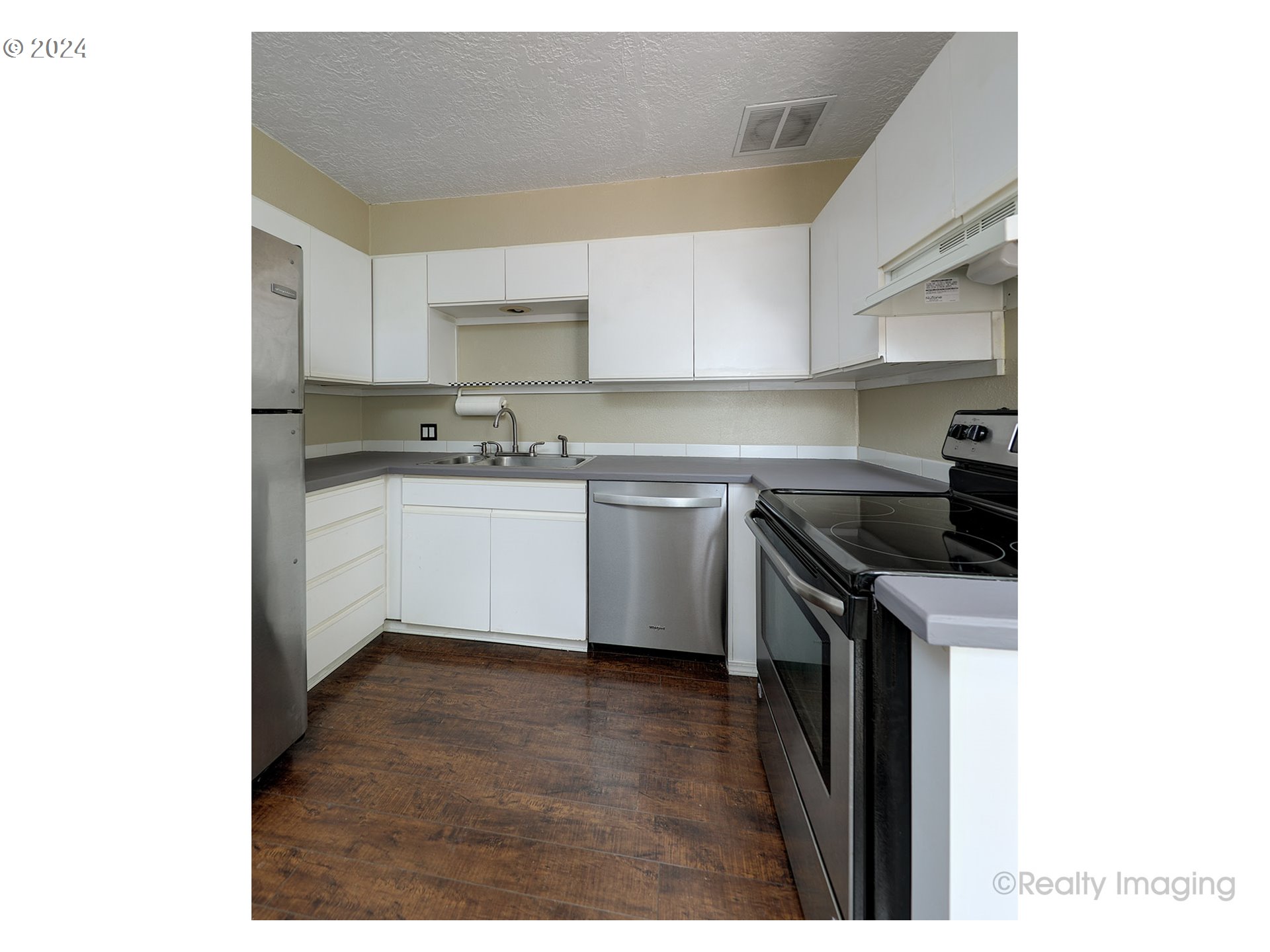 4424 Northeast 115th Avenue Portland, OR 97220 - Photo 10 of 24 a kitchen with a sink a stove and cabinets