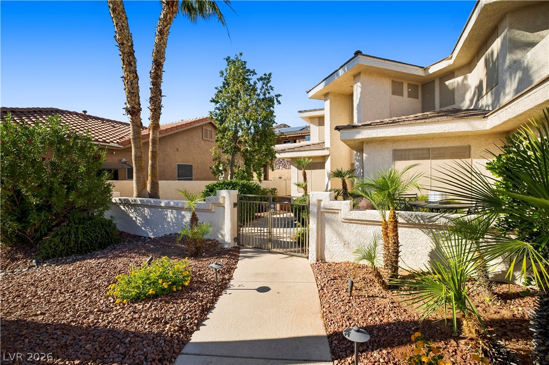 1135 Calico Ridge Drive Henderson, NV 89011 - Photo 5 of 86 A private gated entry welcomes you to this desert oasis featuring mature landscaping and a well-maintained exterior.