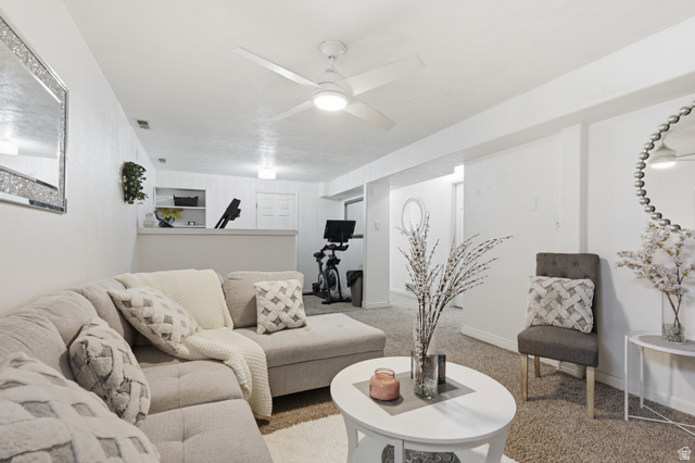 830 North Stone Road Snowville, UT 84336 - Photo 17 of 69 Carpeted living area featuring a ceiling fan and baseboards