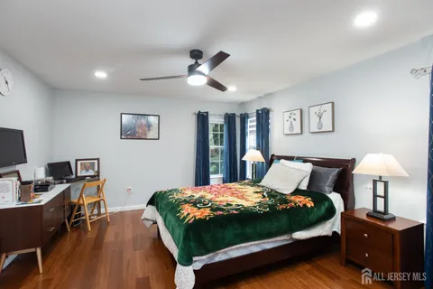 a bedroom with a bed and a desk