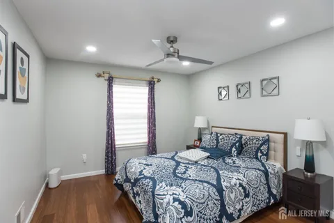 a bedroom with a bed and a night stand