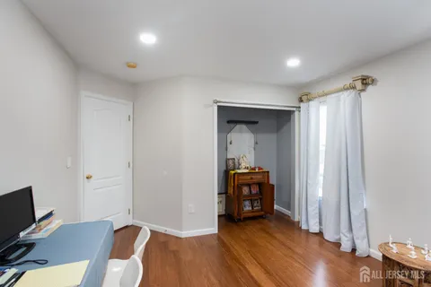 a view of room with furniture and wooden floor