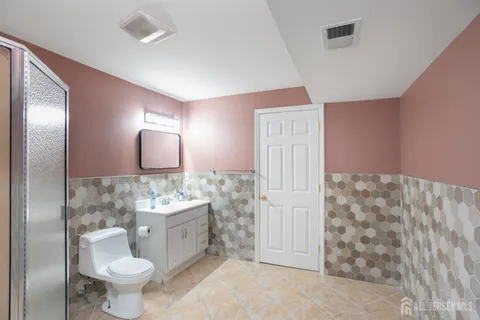 a bathroom with a shower and a glass door